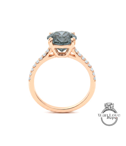A rose gold engagement ring with a large, dark blue gemstone set in the center.