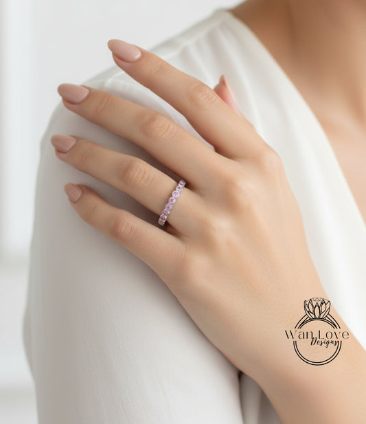 A close-up of a person's hand wearing a ring on the ring finger.