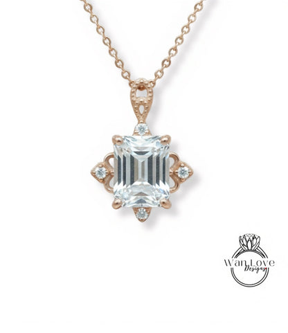 A necklace with a large, clear gemstone pendant, which appears to be a diamond. The pendant is set in a rose gold-colored metal and is surrounded by smaller diamonds.