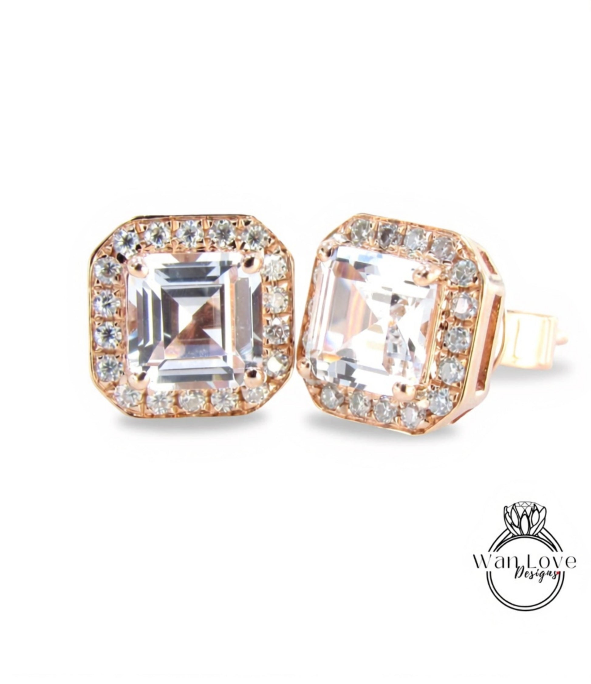 A pair of elegant gold earrings with large, clear gemstones set in a halo around the edges.