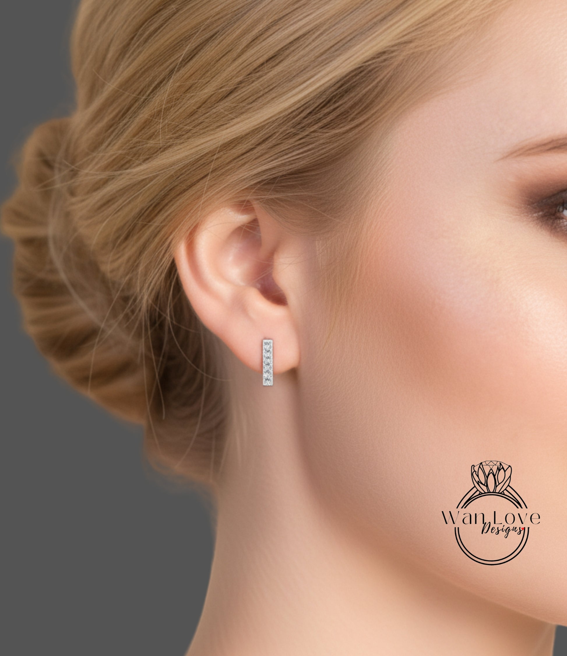 A close-up of a woman's face, focusing on her earrings and hair.