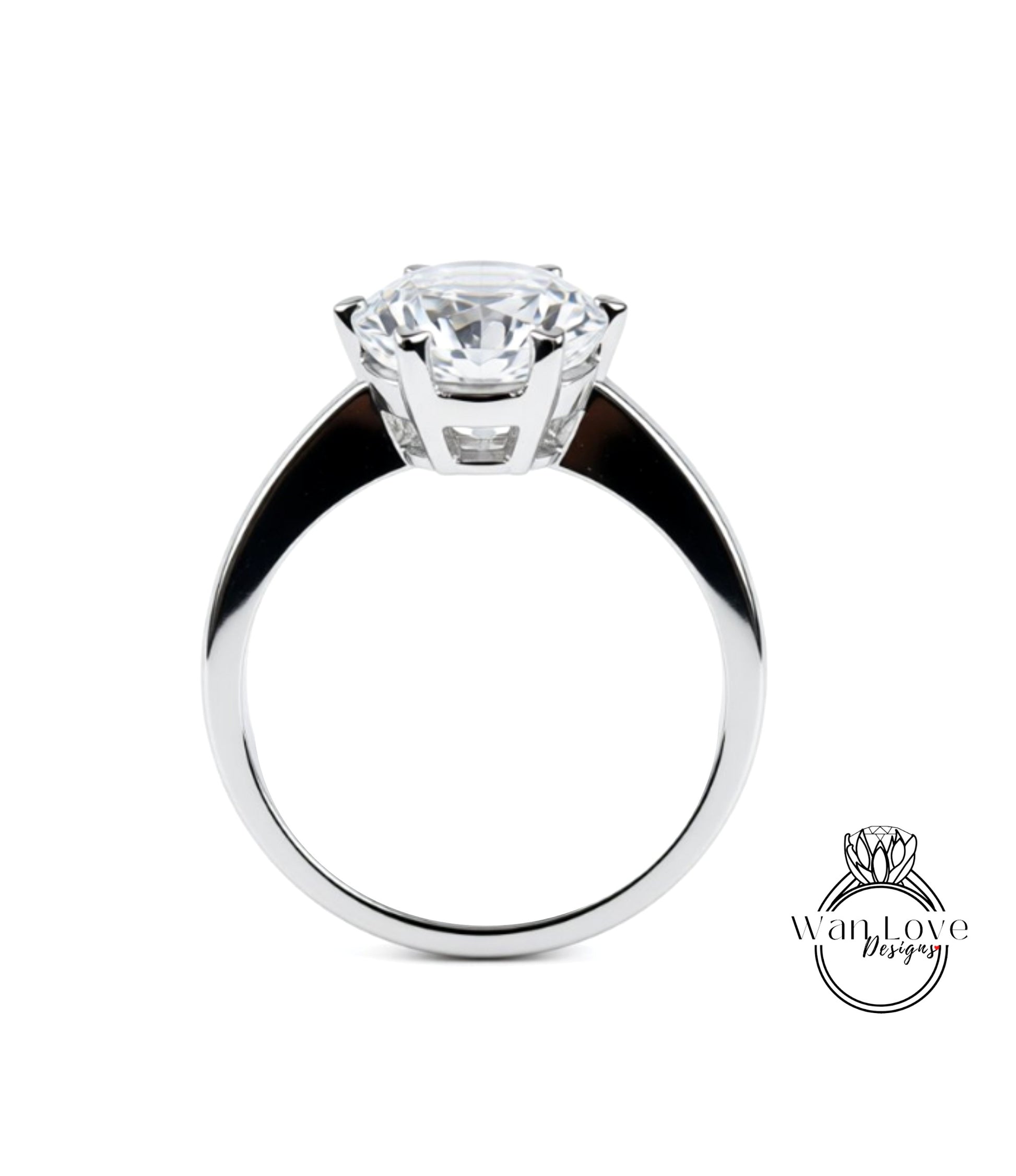 A close-up of a silver ring with a large, clear gemstone set in the center.