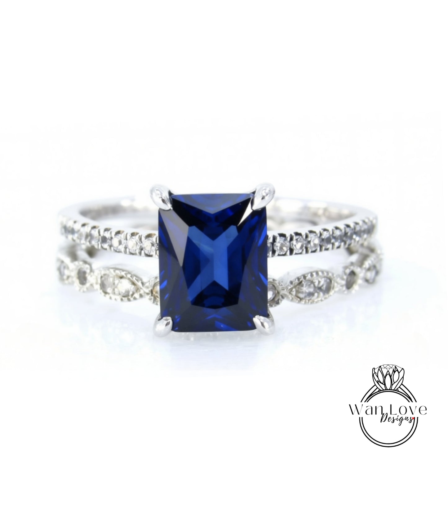 A close-up image of a silver ring with a large blue gemstone, likely a sapphire, set in a diamond band.