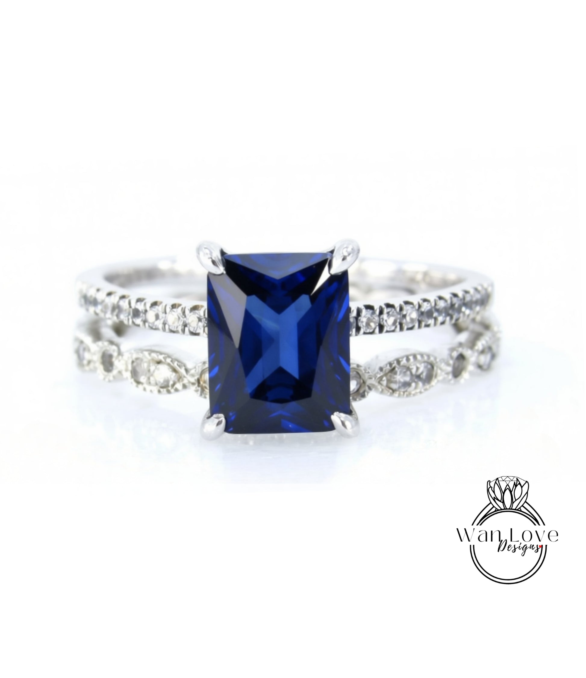 A close-up image of a silver ring with a large blue gemstone, likely a sapphire, set in a diamond band.