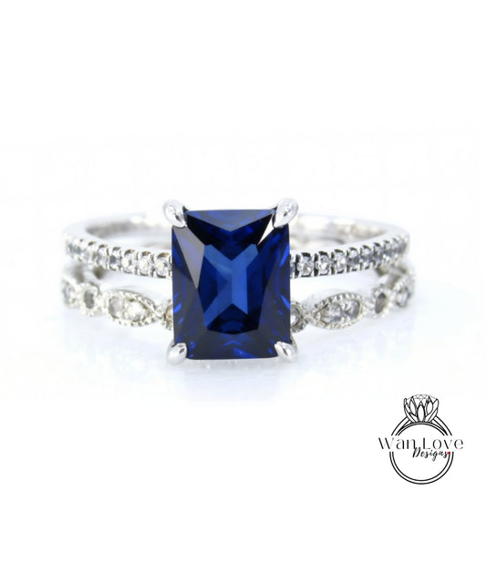 A close-up image of a silver ring with a large blue gemstone, likely a sapphire, set in a diamond band.