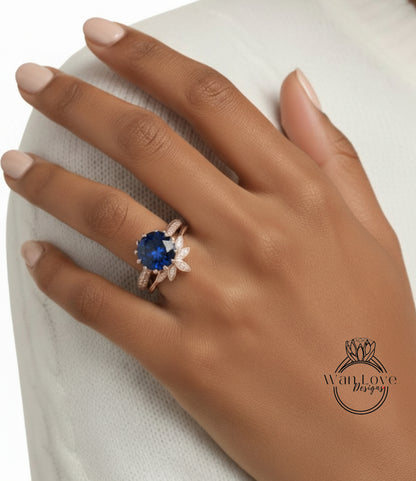 A close-up of a hand wearing a ring with a large blue gemstone, possibly a sapphire or blue topaz.