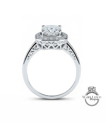A silver engagement ring with a large central diamond surrounded by smaller diamonds, set in an intricate metal band.