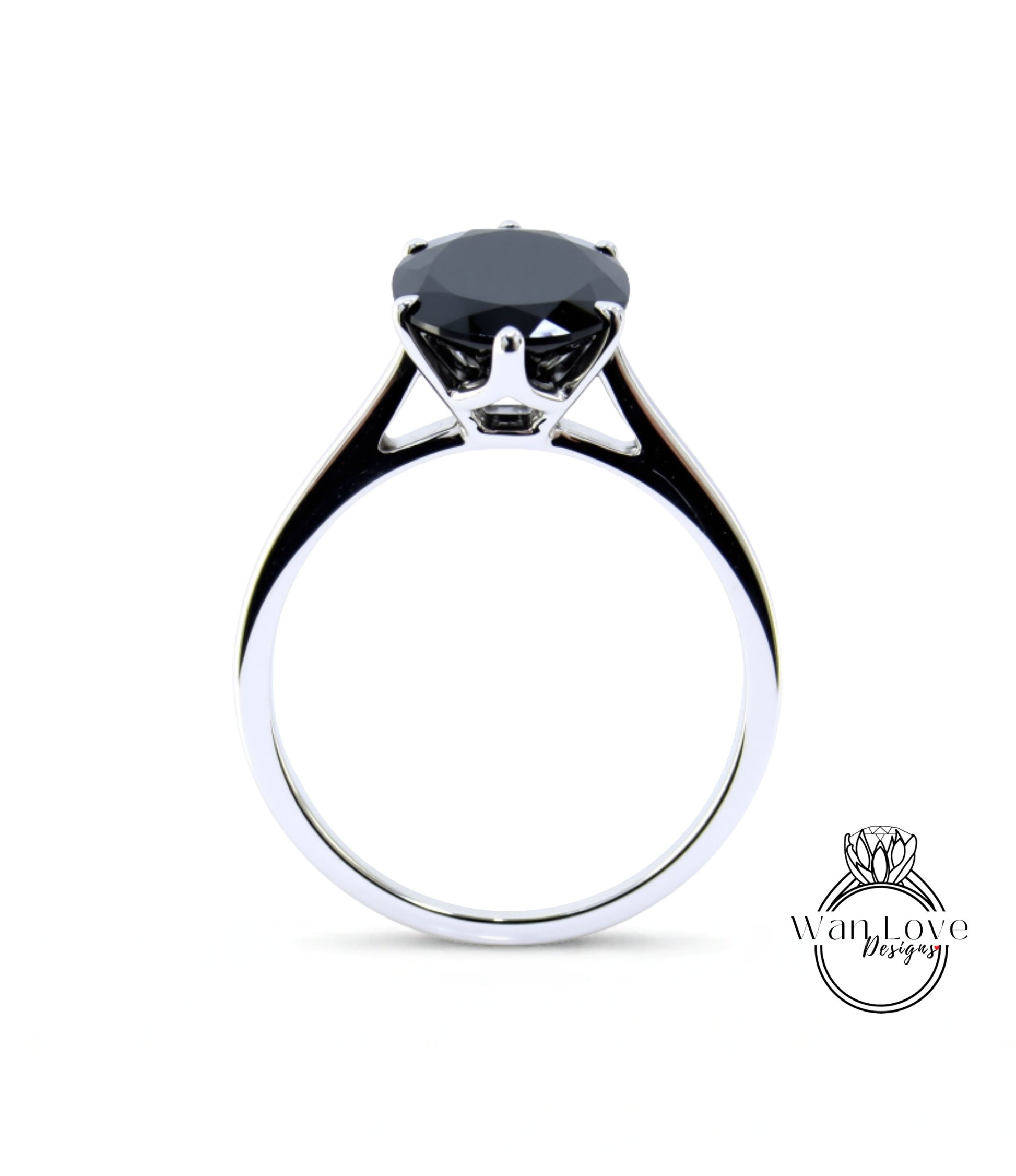 A silver ring with a large black gemstone, likely a diamond, set in the center.