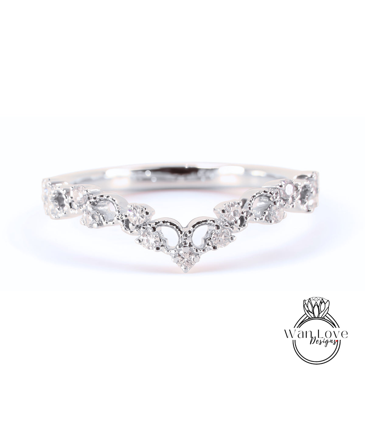 A silver ring with a heart-shaped design and numerous small diamonds set in it.