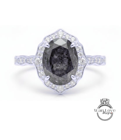 A silver ring with a large oval-shaped diamond at the center, surrounded by smaller diamonds.