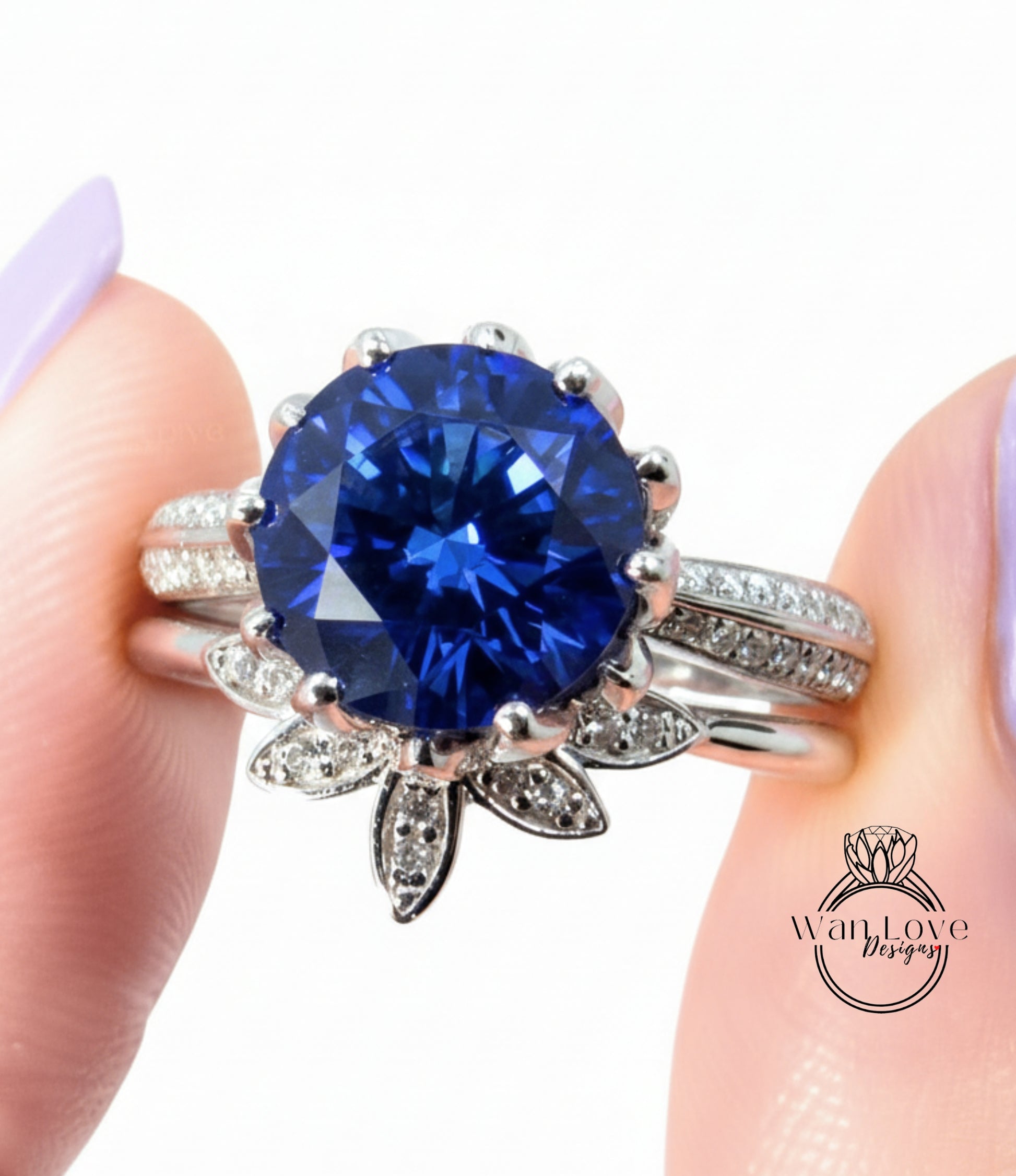 A close-up of a person's hand wearing a silver ring with a large blue gemstone, possibly a sapphire or blue topaz.