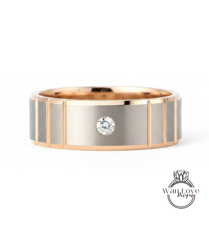 A gold and silver ring with a large diamond set in the center.