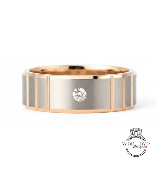 A gold and silver ring with a large diamond set in the center.