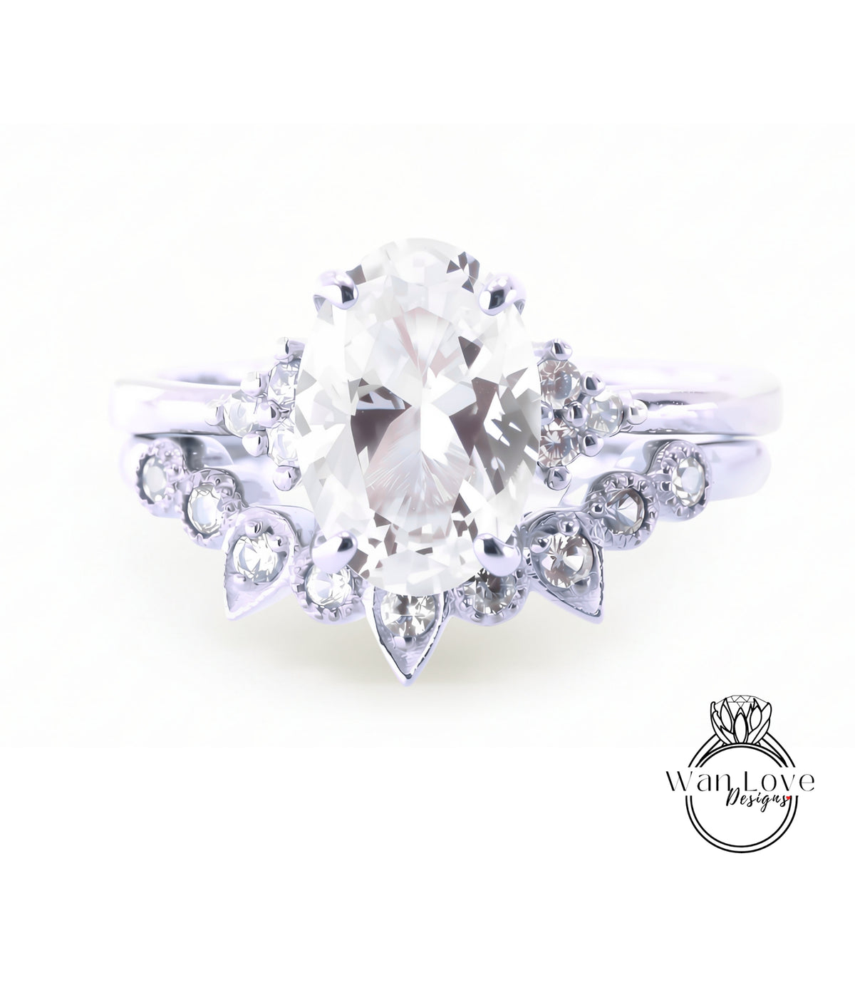 A close-up view of a diamond engagement ring with a large oval-shaped diamond at the center, surrounded by smaller diamonds and a floral-designed band.
