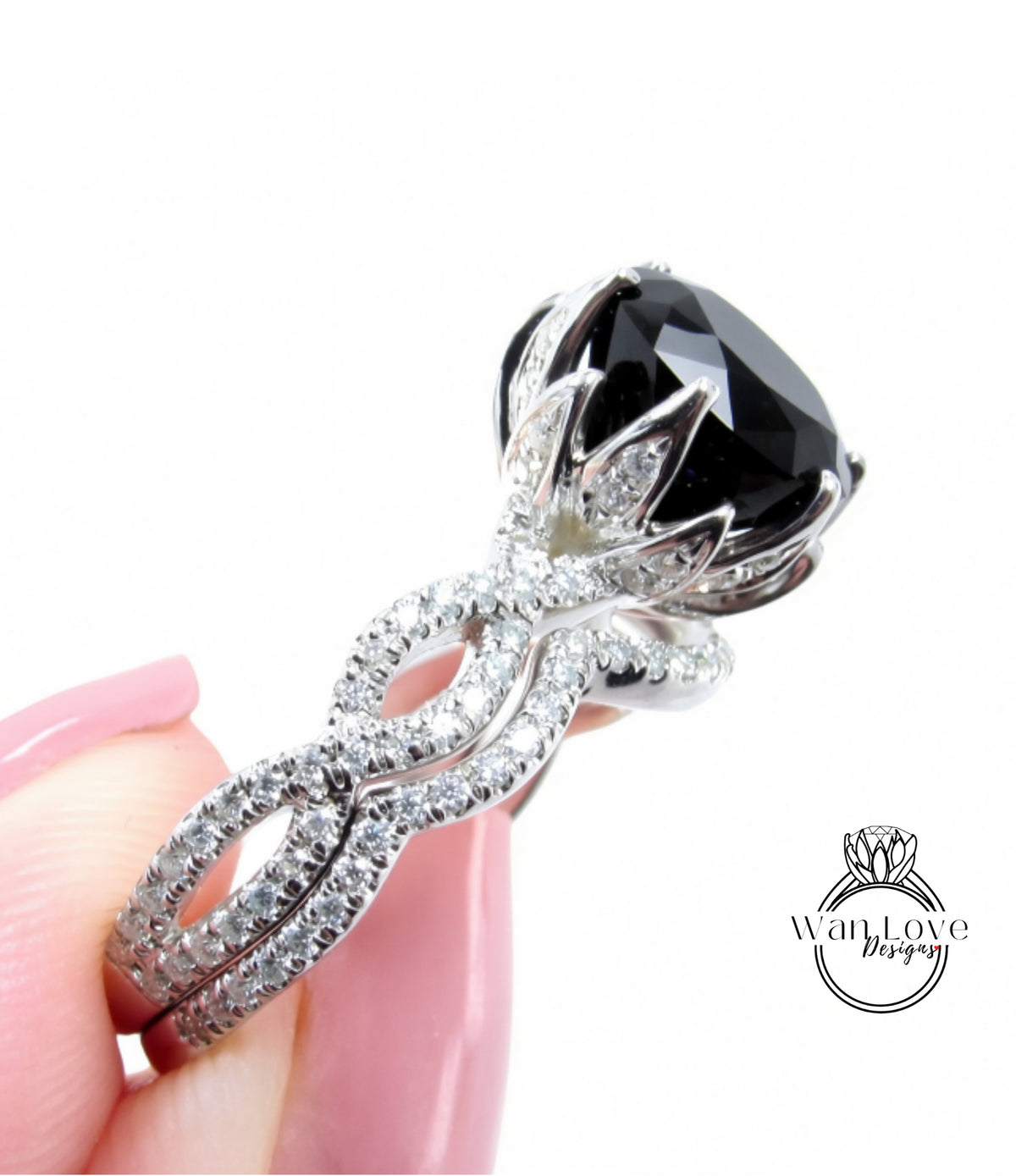 A close-up of a person's hand holding a large, ornate ring with a large black gemstone.
