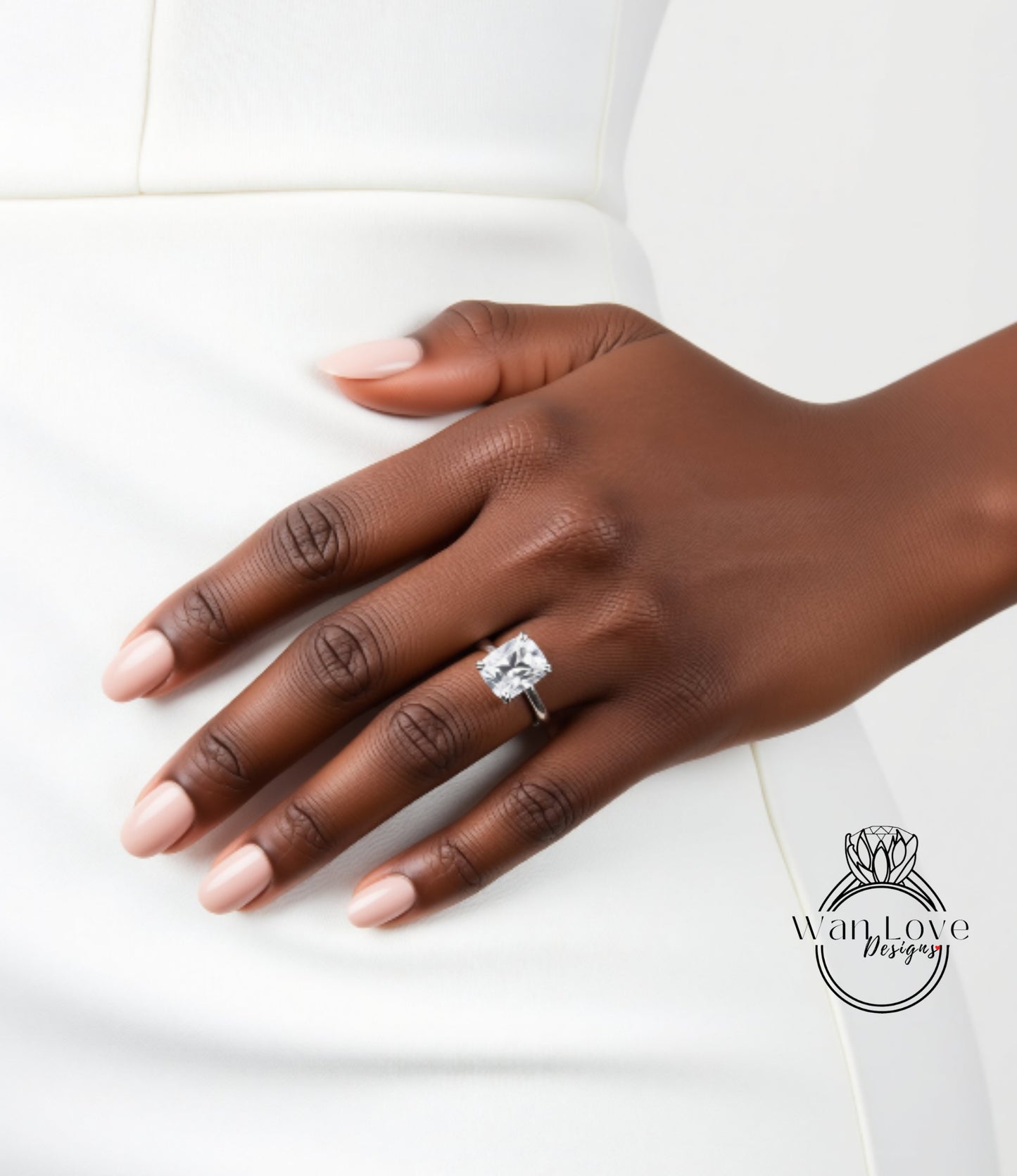 A close-up of a hand wearing a large diamond engagement ring.
