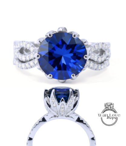 A stunning blue gemstone engagement ring with a large central blue gemstone surrounded by smaller diamonds set in a silver band.