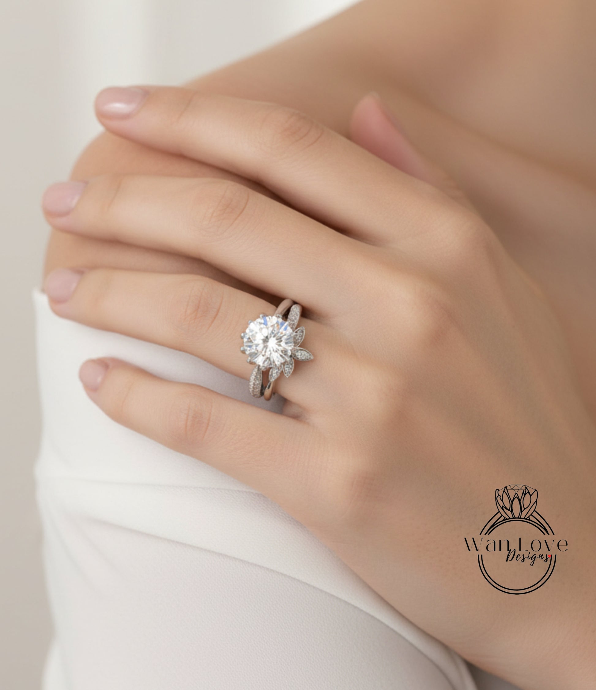 A close-up of a person's hand wearing a large diamond ring on the ring finger.