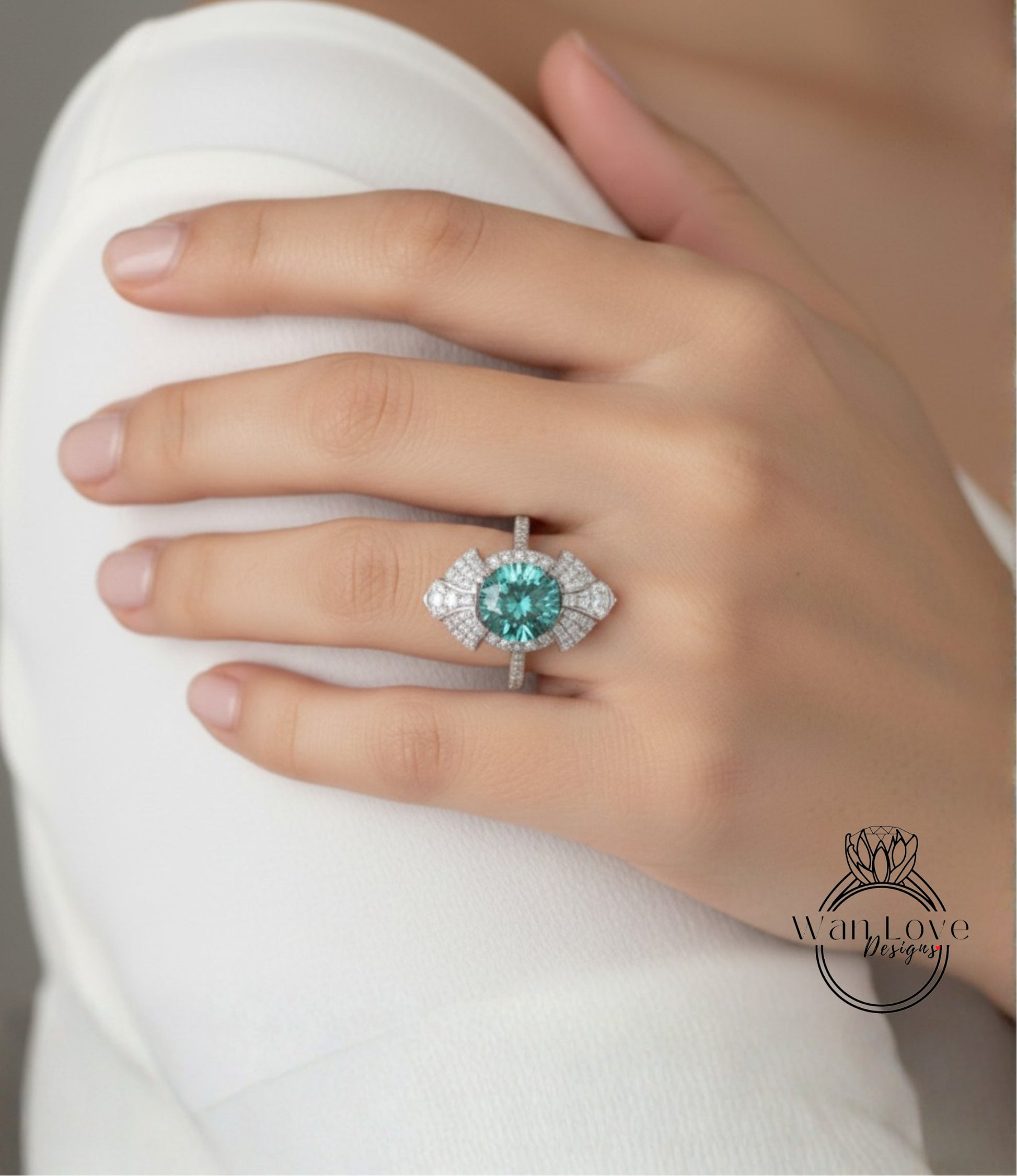 A close-up of a person's hand wearing a large, ornate ring with a large central gemstone surrounded by smaller stones.