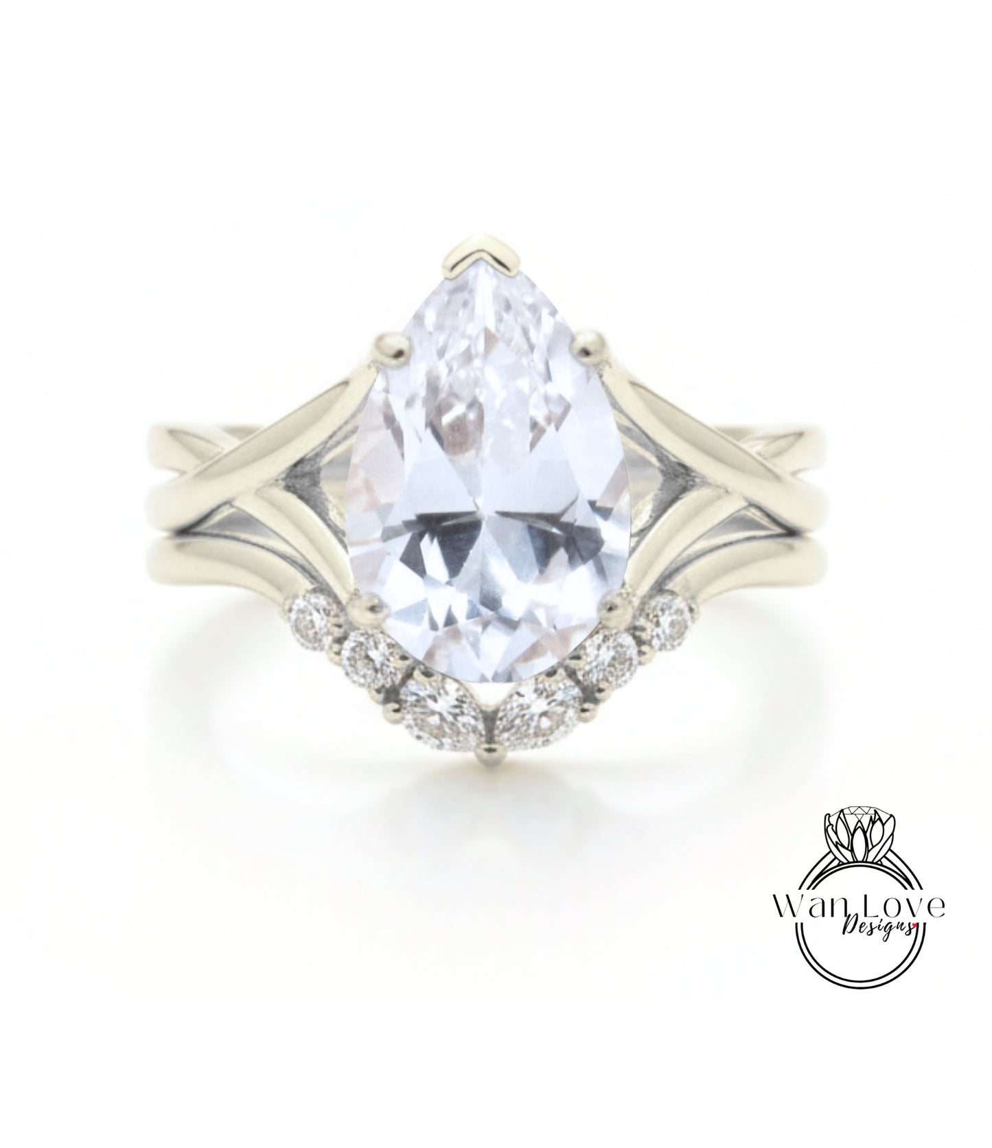 A close-up of a diamond engagement ring with a large pear-shaped gemstone set in a silver band.