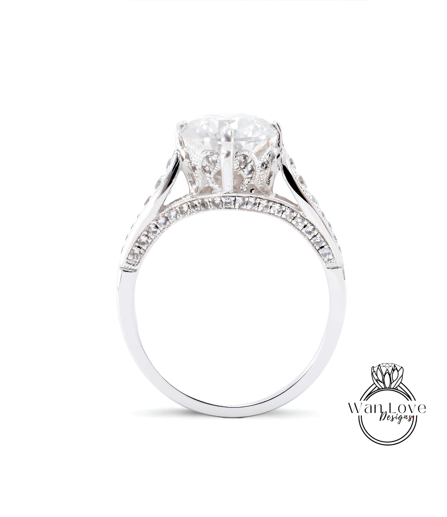 A close-up view of a diamond engagement ring with a large central diamond surrounded by smaller diamonds set in a silver band.