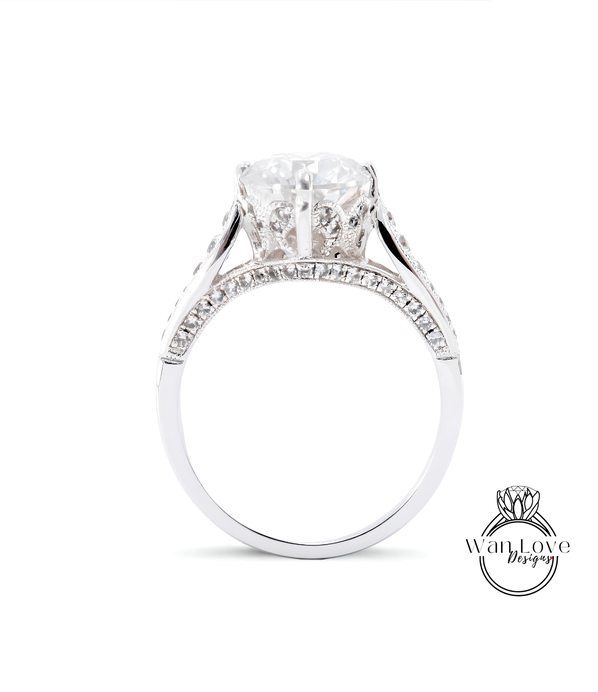 A close-up view of a diamond engagement ring with a large central diamond surrounded by smaller diamonds set in a silver band.
