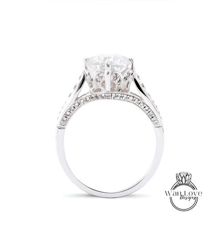 A close-up view of a diamond engagement ring with a large central diamond surrounded by smaller diamonds set in a silver band.