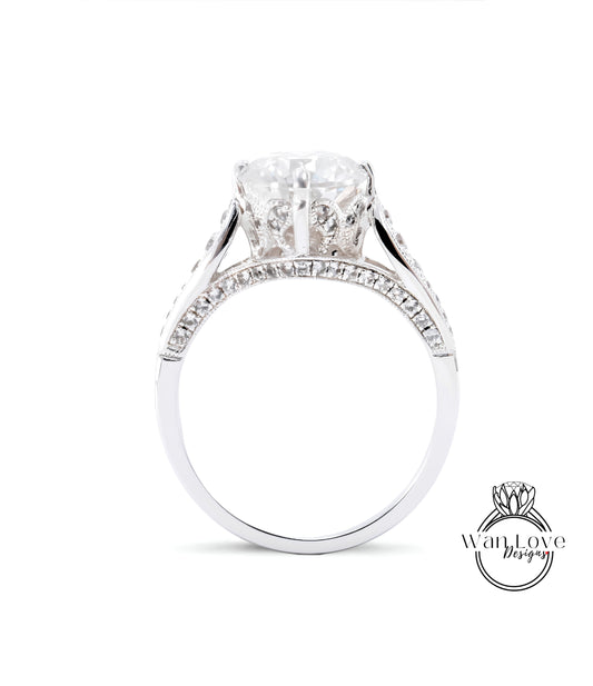A close-up view of a diamond engagement ring with a large central diamond surrounded by smaller diamonds set in a silver band.