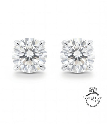A pair of elegant diamond earrings with a large, brilliant-cut diamond set in a silver metal earring.