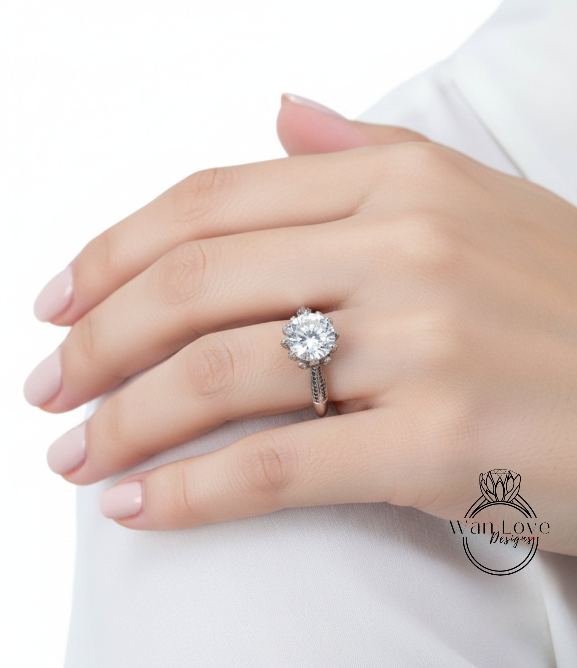 A close-up of a person's hand wearing a diamond engagement ring.