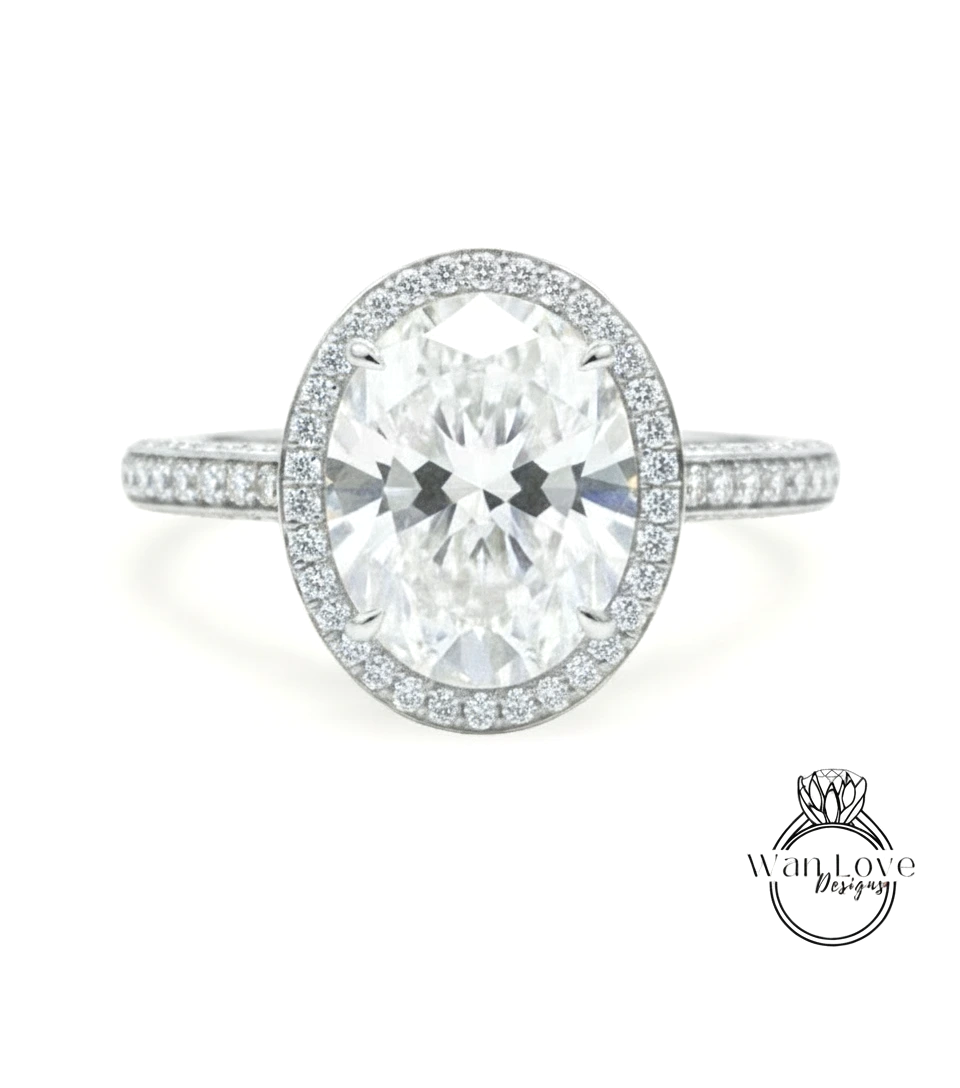 A stunning diamond engagement ring with a large oval-shaped diamond set in a halo of smaller diamonds, surrounded by a band of smaller diamonds.