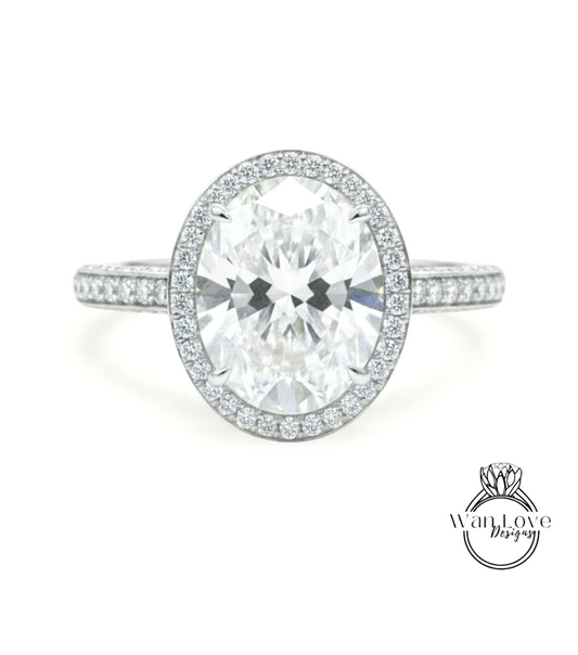 A stunning diamond engagement ring with a large oval-shaped diamond set in a halo of smaller diamonds, surrounded by a band of smaller diamonds.
