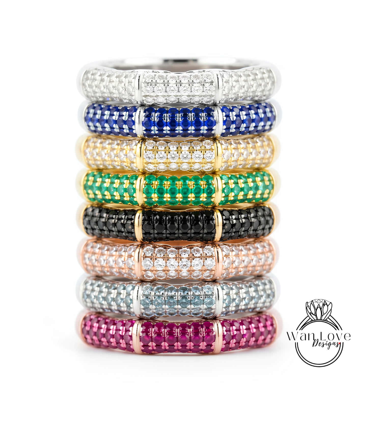 A stack of rings with colorful gemstone bands on top, showcasing various colors and patterns.