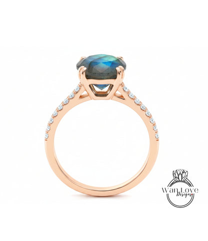 A gold ring with a large blue gemstone, likely a diamond, set in the center.
