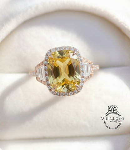A close-up image of a large, yellow gemstone ring with a halo of smaller diamonds around the center stone.