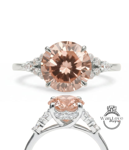 A close-up of a diamond engagement ring with a large, round-cut pink diamond set in a silver band adorned with smaller diamonds.