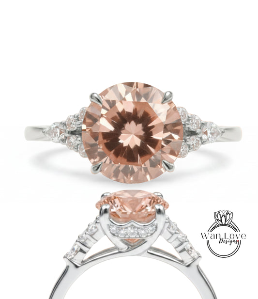 A close-up of a diamond engagement ring with a large, round-cut pink diamond set in a silver band adorned with smaller diamonds.