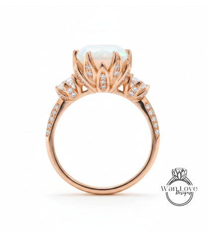 A gold ring with a large opal stone and intricate floral designs on the band.