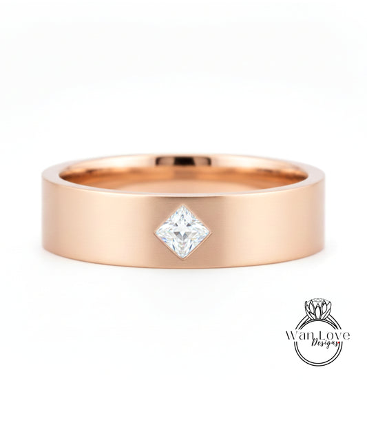A gold-colored ring with a diamond set in the center.