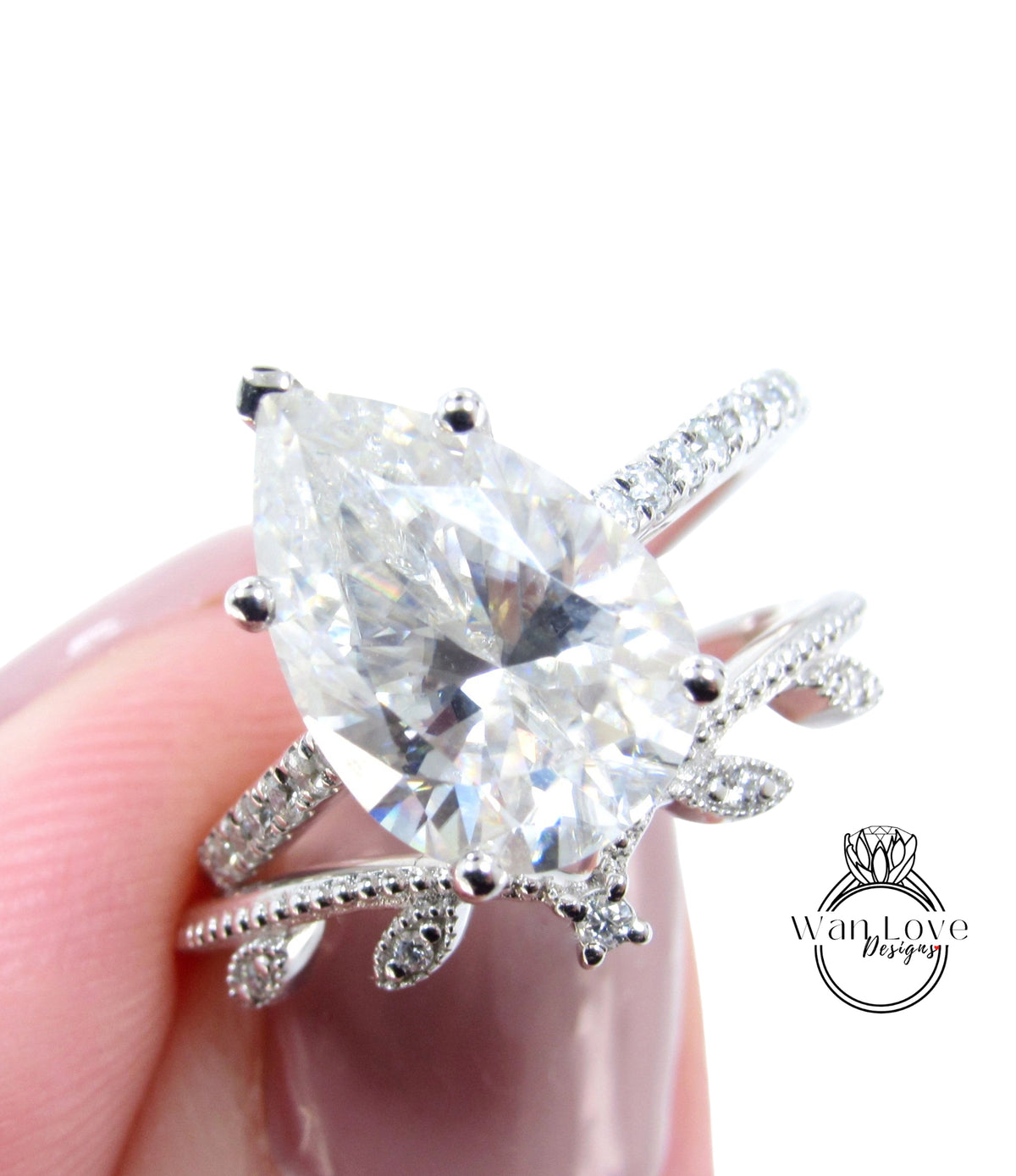 A close-up image of a person's hand holding a diamond engagement ring with a large central diamond surrounded by smaller diamonds on the band.