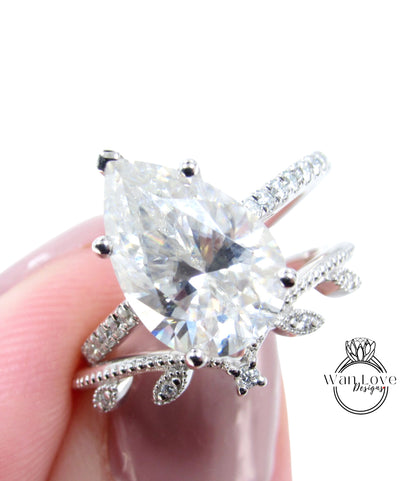 A close-up image of a person's hand holding a diamond engagement ring with a large central diamond surrounded by smaller diamonds on the band.
