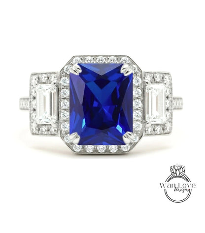 A stunning blue gemstone ring with a halo of diamonds around it, showcasing the intricate design and craftsmanship.