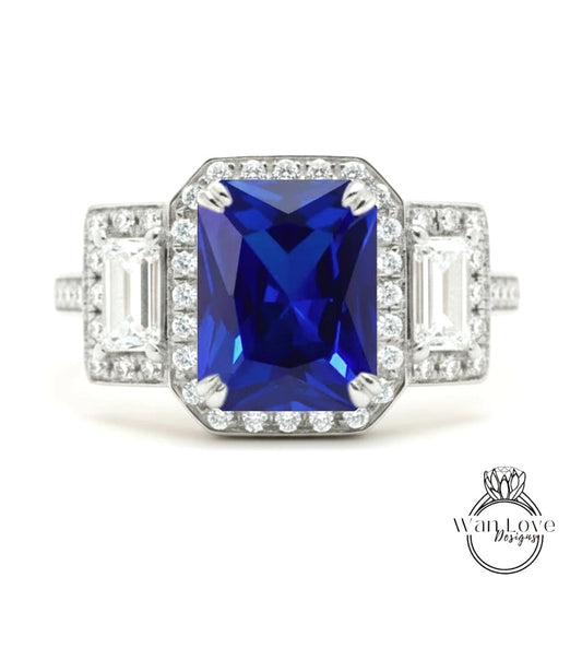 A stunning blue gemstone ring with a halo of diamonds around it, showcasing the intricate design and craftsmanship.