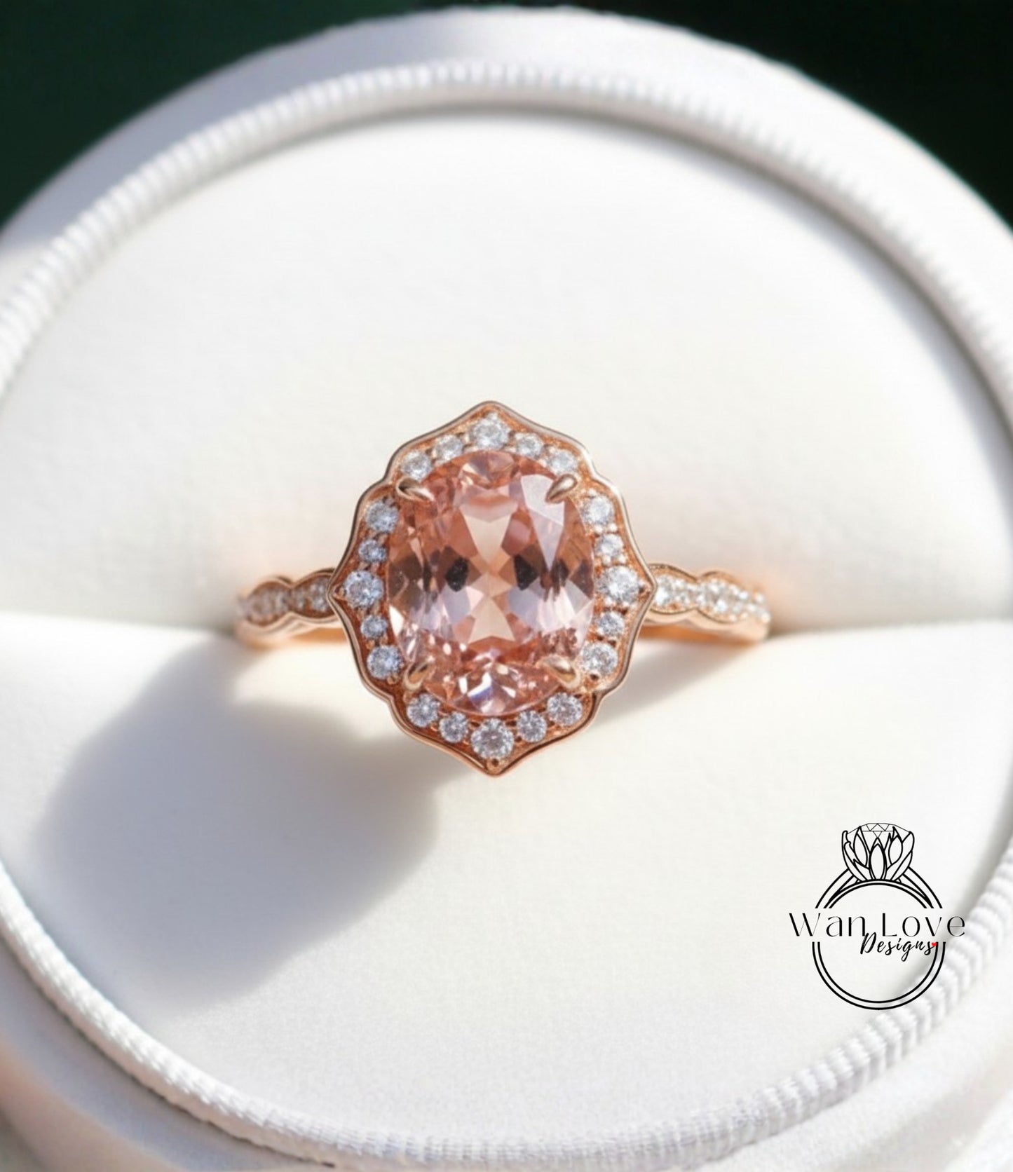 A close-up image of a beautiful pink gemstone ring displayed in a white jewelry box.