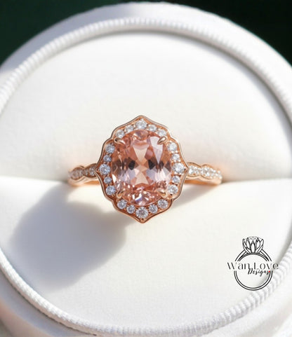 A close-up image of a beautiful pink gemstone ring displayed in a white jewelry box.