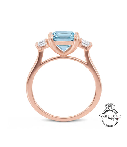 A rose gold engagement ring with a large blue gemstone set in the center, surrounded by smaller diamonds.