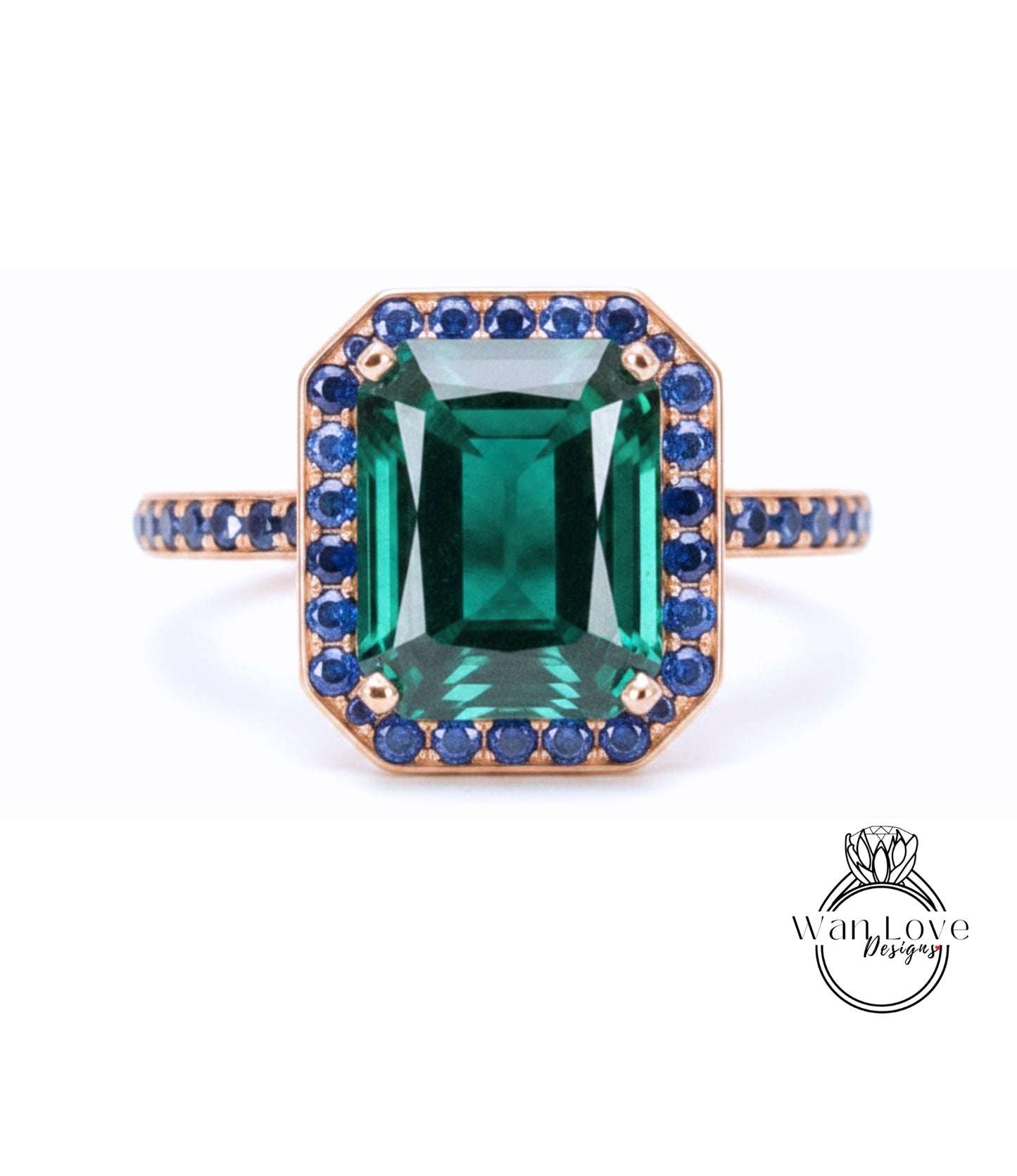 A large, rectangular green gemstone set in a gold ring with a blue gemstone border.