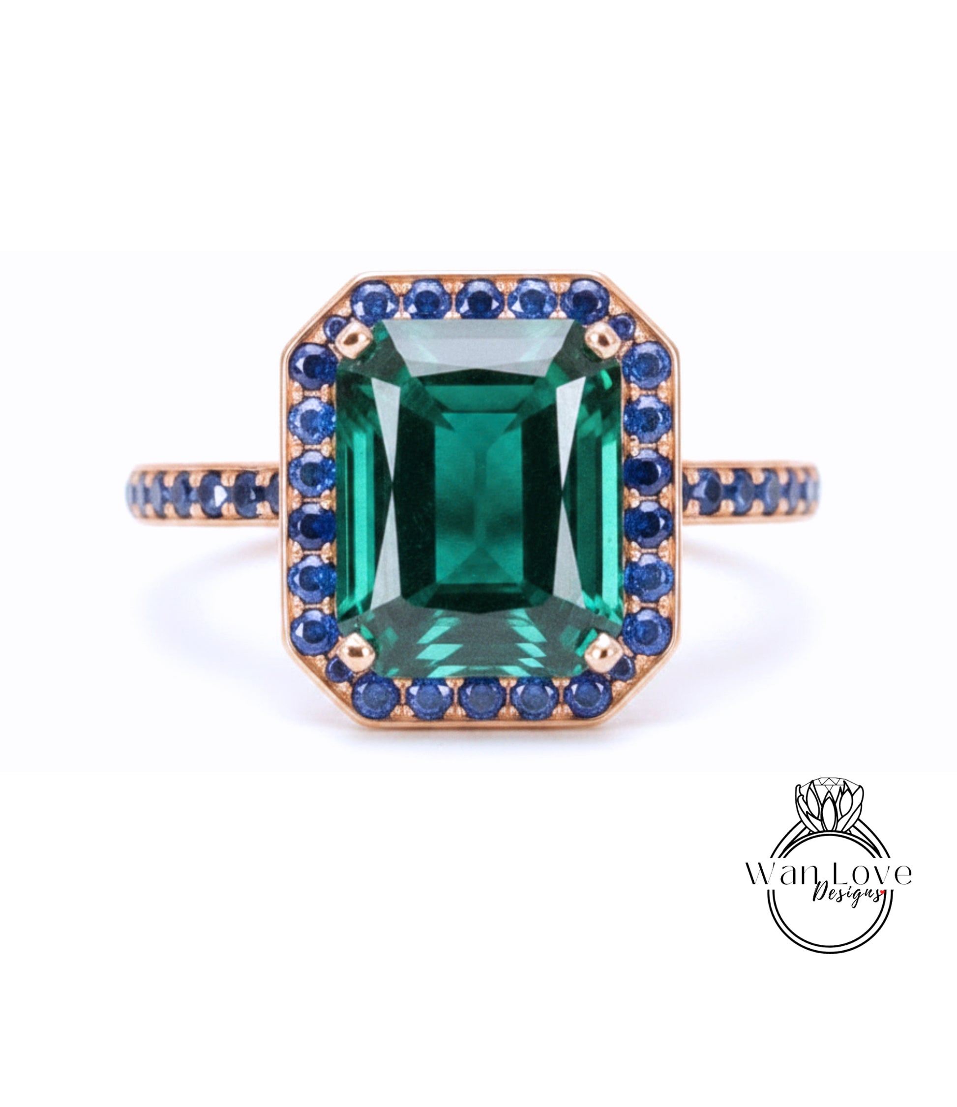 A large, rectangular green gemstone set in a gold ring with a blue gemstone border.