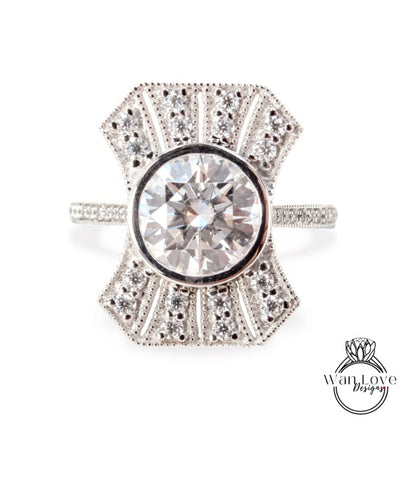 A diamond engagement ring with a large central diamond surrounded by smaller diamonds set in a decorative pattern.