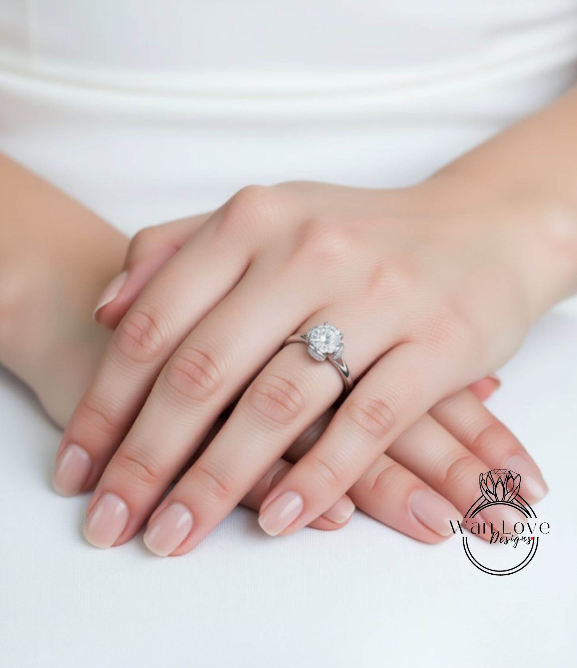 A close-up image of a person's hands wearing a diamond engagement ring.